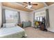 Comfortable bedroom with ceiling fan, dresser, large windows, and a vanity for getting ready at 12920 N Oakhaven Dr, Camby, IN 46113