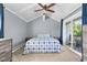 Bedroom features a ceiling fan, carpeting, patio doors to deck and blue accent wall at 12920 N Oakhaven Dr, Camby, IN 46113