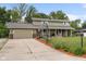 Inviting two-story home featuring a spacious driveway, a basketball hoop, and a charming covered porch at 12920 N Oakhaven Dr, Camby, IN 46113
