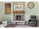 Close-up of a cozy brick fireplace with decorative accents in a comfortable living room at 12920 N Oakhaven Dr, Camby, IN 46113
