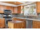 Bright kitchen featuring wood cabinets, stainless steel appliances, and hardwood floors at 12920 N Oakhaven Dr, Camby, IN 46113