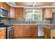 Kitchen featuring wood cabinets, stainless steel appliances, and hardwood floors at 12920 N Oakhaven Dr, Camby, IN 46113
