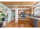 Open kitchen with wood cabinets, stainless steel appliances, and hardwood floors at 12920 N Oakhaven Dr, Camby, IN 46113