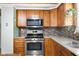 Kitchen with wood cabinets, stainless steel appliances, and mosaic tile backsplash at 12920 N Oakhaven Dr, Camby, IN 46113