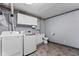 Functional laundry room with a washer, dryer, toilet, and storage cabinets at 12920 N Oakhaven Dr, Camby, IN 46113