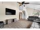 Cozy living room with vaulted ceilings, modern decor, a ceiling fan, and a carpeted floor at 12920 N Oakhaven Dr, Camby, IN 46113