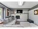 Comfortable living room with a fireplace, television and a large gray sectional sofa at 12920 N Oakhaven Dr, Camby, IN 46113