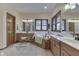 Well-lit bathroom featuring double vanity, soaking tub, and wood-framed mirrors at 1344 S Fox Paw Dr, New Palestine, IN 46163