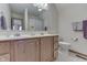 Well-lit bathroom with a double sink vanity, neutral tile, and ample mirror space at 1344 S Fox Paw Dr, New Palestine, IN 46163