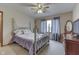 Comfortable bedroom featuring plush carpeting, traditional decor, and a ceiling fan at 1344 S Fox Paw Dr, New Palestine, IN 46163