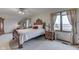 Charming bedroom featuring hardwood accents, neutral carpeting, and natural light from the window at 1344 S Fox Paw Dr, New Palestine, IN 46163