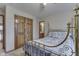Spacious bedroom showcasing a brass bed frame and carpeted floors at 1344 S Fox Paw Dr, New Palestine, IN 46163