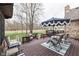 Outdoor deck with outdoor seating overlooking a grassy yard and pond at 1344 S Fox Paw Dr, New Palestine, IN 46163