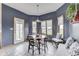 Charming dining room featuring a round table, blue walls, and bright natural light at 1344 S Fox Paw Dr, New Palestine, IN 46163