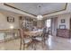 Elegant dining room with hardwood floors, a classic chandelier, and refined furnishings at 1344 S Fox Paw Dr, New Palestine, IN 46163