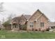 Classic brick home with a lovely garden, showcasing timeless architectural details at 1344 S Fox Paw Dr, New Palestine, IN 46163