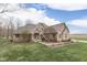 Charming brick home with a manicured lawn and mature trees, reflecting curb appeal at 1344 S Fox Paw Dr, New Palestine, IN 46163