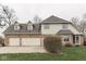 Inviting two-story home featuring a three-car garage, brick accents, and well-maintained landscaping at 1344 S Fox Paw Dr, New Palestine, IN 46163