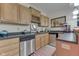 Kitchen with light wood cabinets and stainless steel appliances at 1344 S Fox Paw Dr, New Palestine, IN 46163