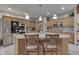 Bright kitchen featuring a large island with bar seating and stainless steel appliances at 1344 S Fox Paw Dr, New Palestine, IN 46163