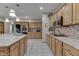 Spacious kitchen with wooden cabinets, granite countertops, and stainless steel appliances at 1344 S Fox Paw Dr, New Palestine, IN 46163