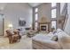 Bright living room features a fireplace, high ceilings, and comfortable seating at 1344 S Fox Paw Dr, New Palestine, IN 46163
