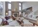 Open-concept living room with a cozy fireplace and plenty of natural light at 1344 S Fox Paw Dr, New Palestine, IN 46163