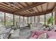 Screened porch with comfortable seating and a swing at 1344 S Fox Paw Dr, New Palestine, IN 46163
