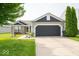 Charming single Gathering home with a well-manicured lawn, brick accents, and an attached two-car garage at 1414 Dowell St, Greenwood, IN 46143