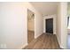 Inviting entryway with sleek wood flooring and neutral paint, with adjacent open living spaces at 1414 Dowell St, Greenwood, IN 46143