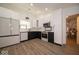 Modern two-tone kitchen featuring stainless steel appliances, white cabinets, and ample counter space at 1414 Dowell St, Greenwood, IN 46143