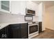 Modern two-tone kitchen featuring stainless steel appliances, white cabinets, and ample counter space at 1414 Dowell St, Greenwood, IN 46143