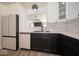 Modern two-tone kitchen featuring stainless steel appliances, white cabinets, and ample counter space at 1414 Dowell St, Greenwood, IN 46143