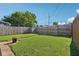 Spacious backyard with lush lawn, wooden privacy fence, and flower pot at 1421 S New Jersey St, Indianapolis, IN 46225