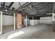 Unfinished basement with exposed brick, dark ceiling beams, and concrete floor at 1421 S New Jersey St, Indianapolis, IN 46225