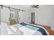 Comfortable bedroom with hardwood floors and en-suite bathroom at 1421 S New Jersey St, Indianapolis, IN 46225