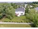 Aerial view of a white home with a spacious backyard and patio area at 14353 Chariots Whisper Dr, Carmel, IN 46074