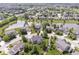Aerial view of a neighborhood with a pond and homes with well-maintained lawns and landscaping at 14353 Chariots Whisper Dr, Carmel, IN 46074