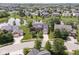 Aerial view of a neighborhood featuring large homes, mature trees, and a pond at 14353 Chariots Whisper Dr, Carmel, IN 46074