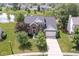 Beautiful brick home featuring mature landscaping, a spacious driveway, and picturesque pond views at 14353 Chariots Whisper Dr, Carmel, IN 46074