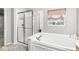 Clean bathroom featuring a combined shower and tub with a white tile surround at 14353 Chariots Whisper Dr, Carmel, IN 46074