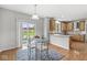 Bright breakfast nook with hardwood floors and sliding door to the backyard at 14353 Chariots Whisper Dr, Carmel, IN 46074