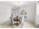 Cozy dining room features a round table with seating for four and an elegant chandelier at 14353 Chariots Whisper Dr, Carmel, IN 46074