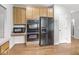 Kitchen appliances, with hardwood floors at 14353 Chariots Whisper Dr, Carmel, IN 46074