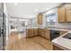 Open kitchen with hardwood floors and view to living and dining areas at 14353 Chariots Whisper Dr, Carmel, IN 46074