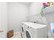 Functional laundry room equipped with a washer, dryer, and ample storage space at 14353 Chariots Whisper Dr, Carmel, IN 46074