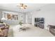 Cozy living room with neutral walls and view of kitchen at 14353 Chariots Whisper Dr, Carmel, IN 46074