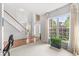 Light-filled living room with a staircase, large windows, and neutral carpet at 14353 Chariots Whisper Dr, Carmel, IN 46074