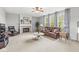 Cozy living room featuring a fireplace, plush seating, and abundant natural light at 14353 Chariots Whisper Dr, Carmel, IN 46074