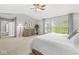 Sunlit main bedroom boasting a dresser, a view of the water, and a ceiling fan at 14353 Chariots Whisper Dr, Carmel, IN 46074